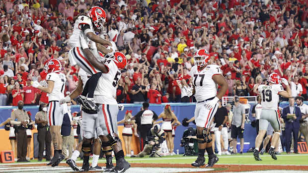Dec 31, 2021; Miami Gardens, Florida, USA; Georgia Bulldogs running back James Cook (4) and offensive lineman Justin Shaffer (54) celebrate Cook's touchdown against the Michigan Wolverines during the second half of the Orange Bowl college football CFP national semifinal game at Hard Rock Stadium. Mandatory Credit: Rhona Wise-USA TODAY Sports

